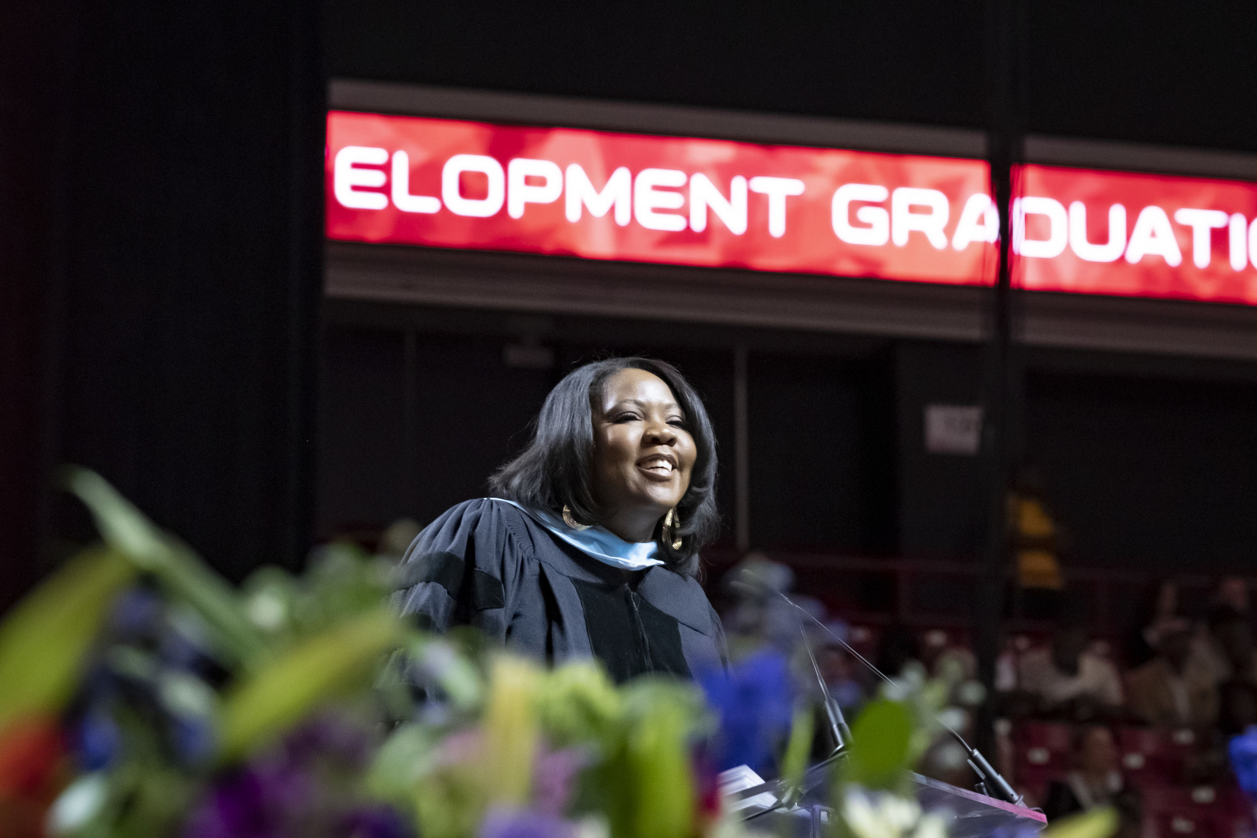 Keynote speaker stands at podium addressing attendees