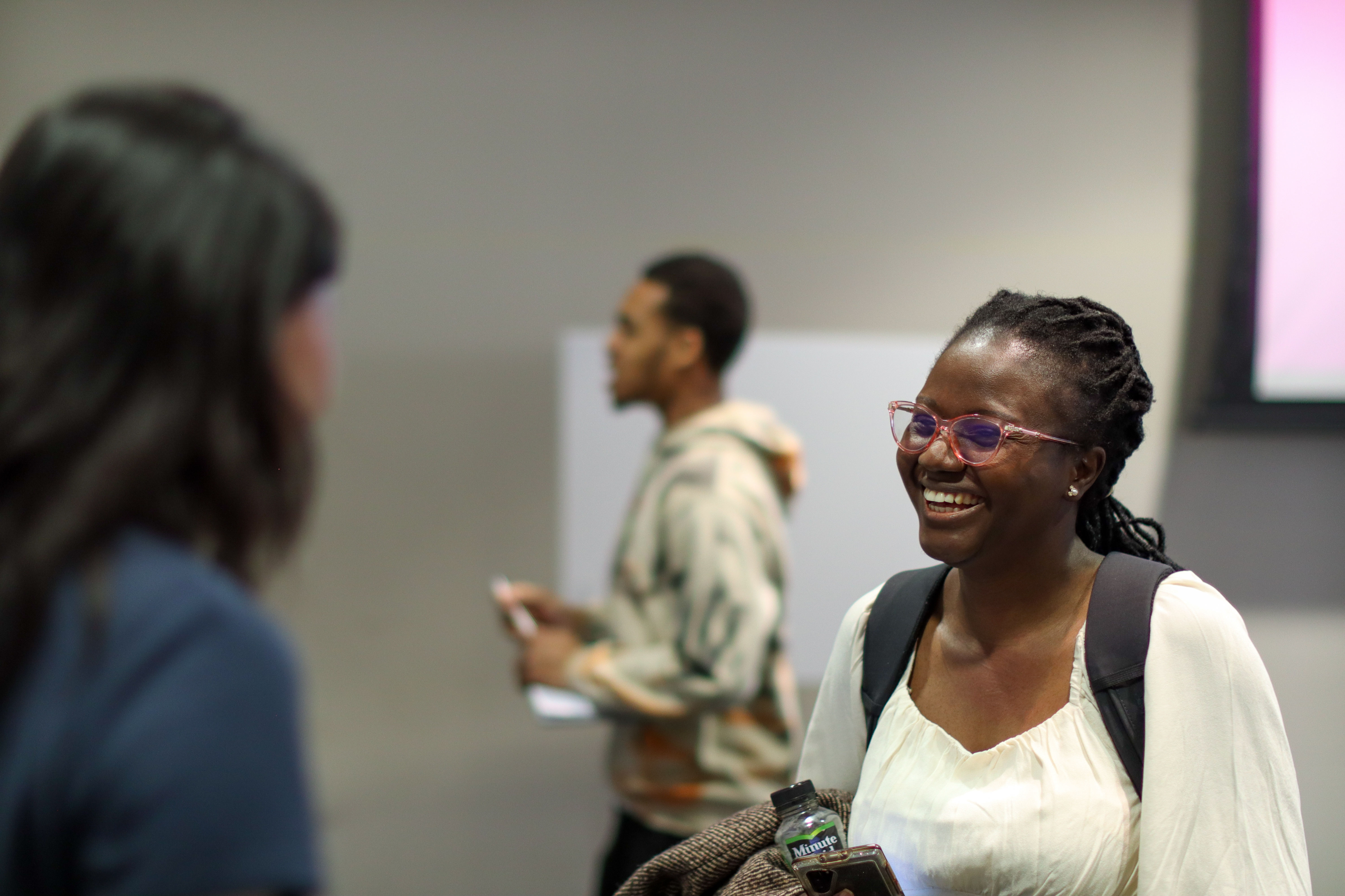 Two female students engage during poster session