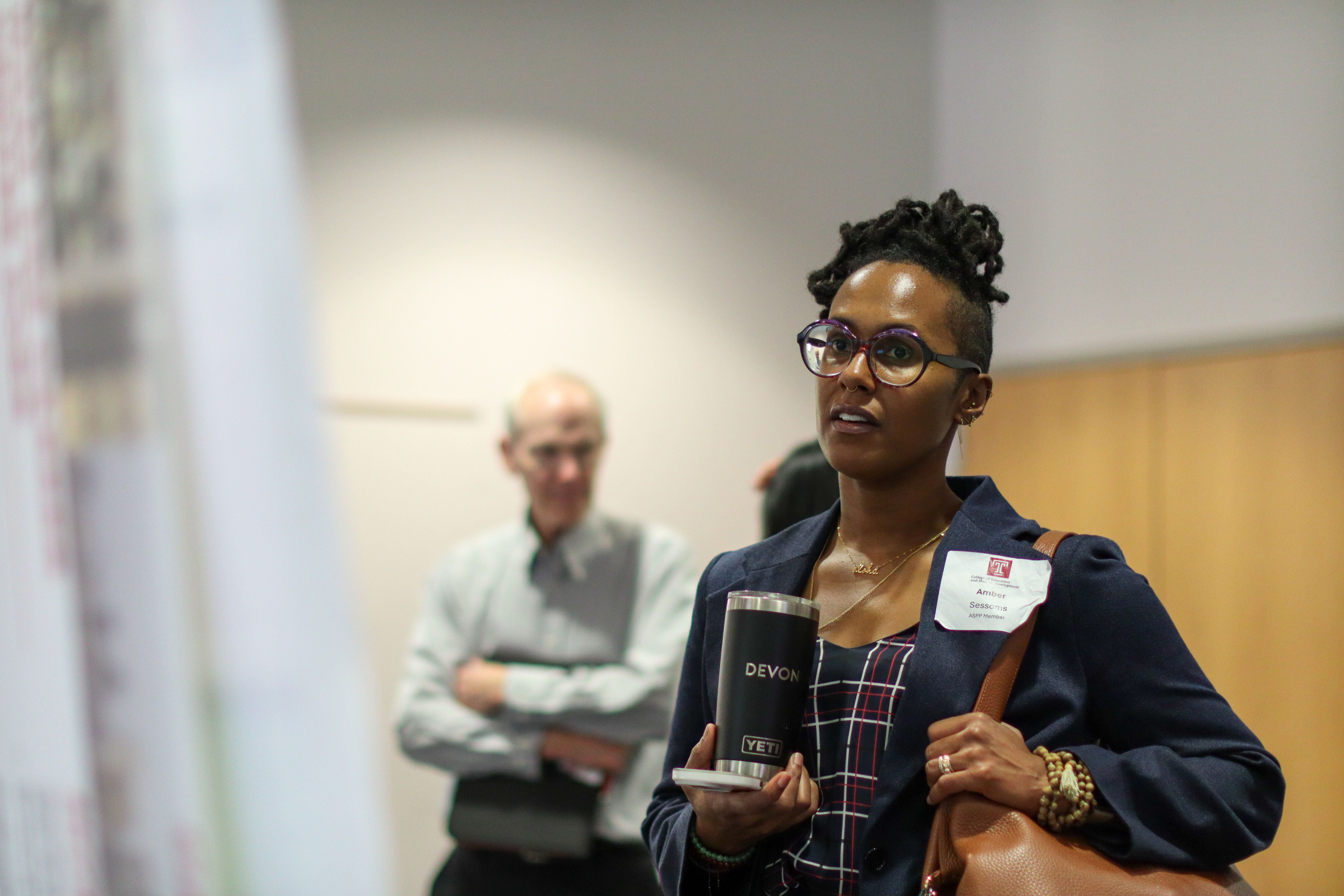 Conference participant looks at student research poster