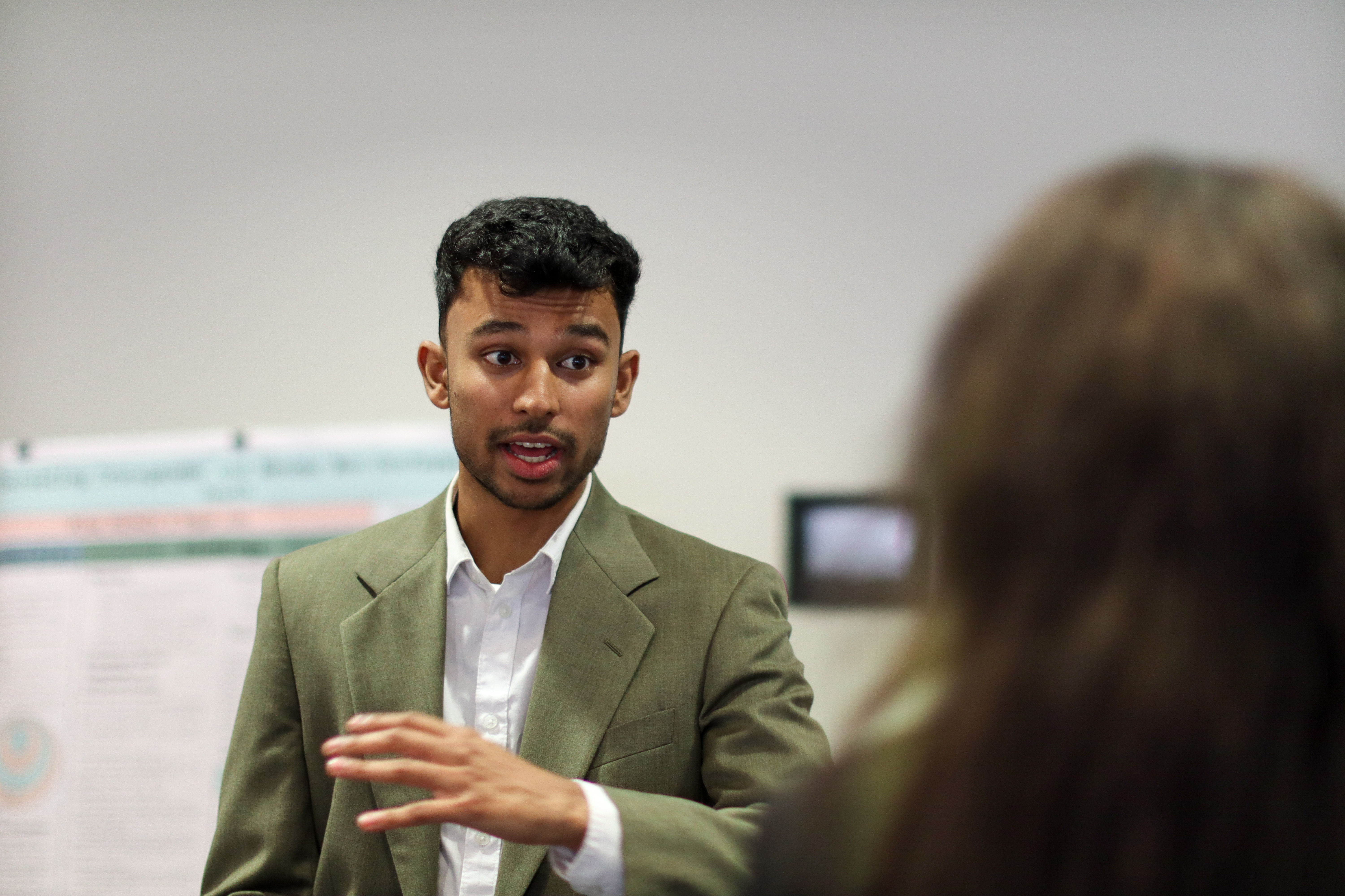 Student talking with another during poster session