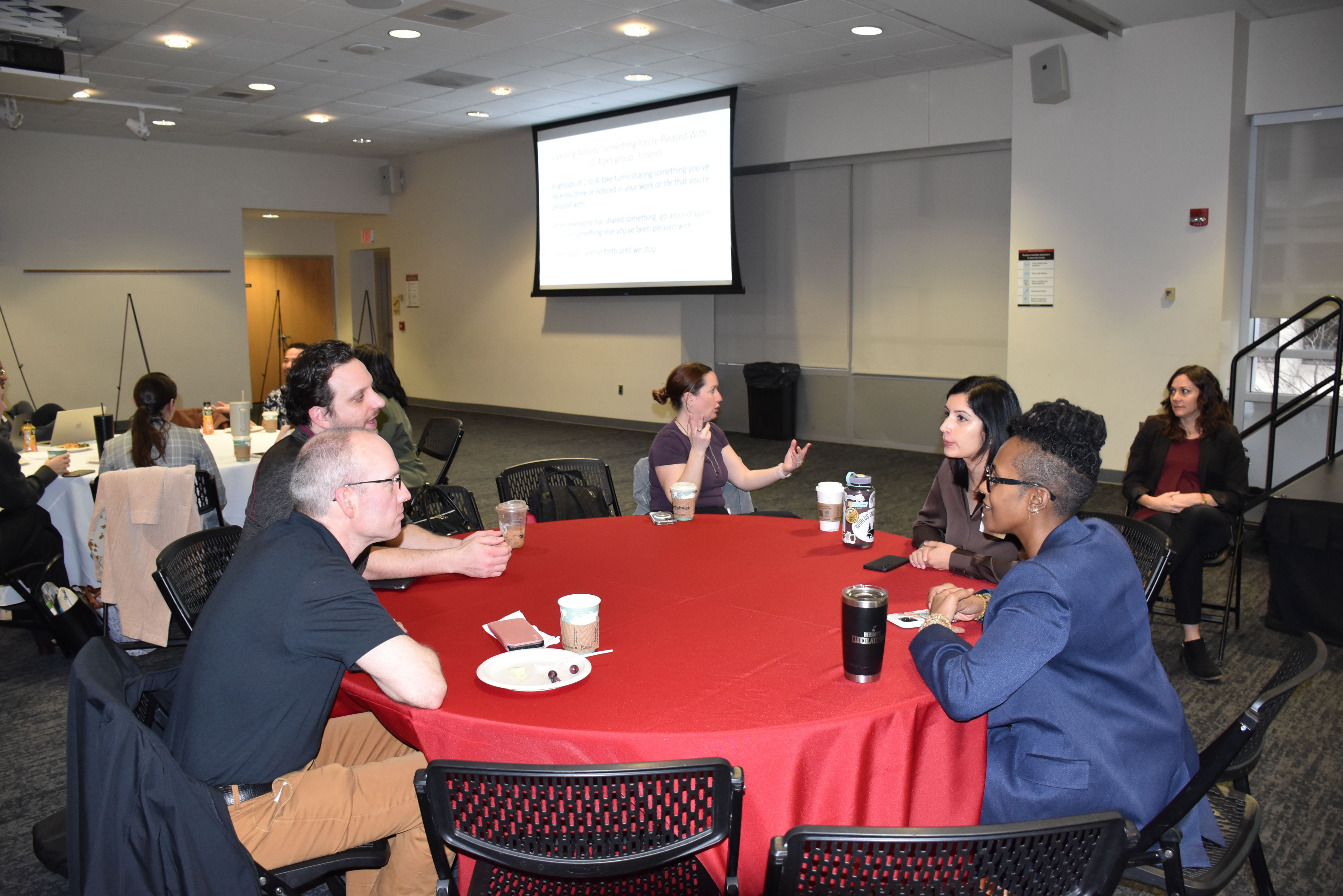 Conference participants engaging in dialogue at round table