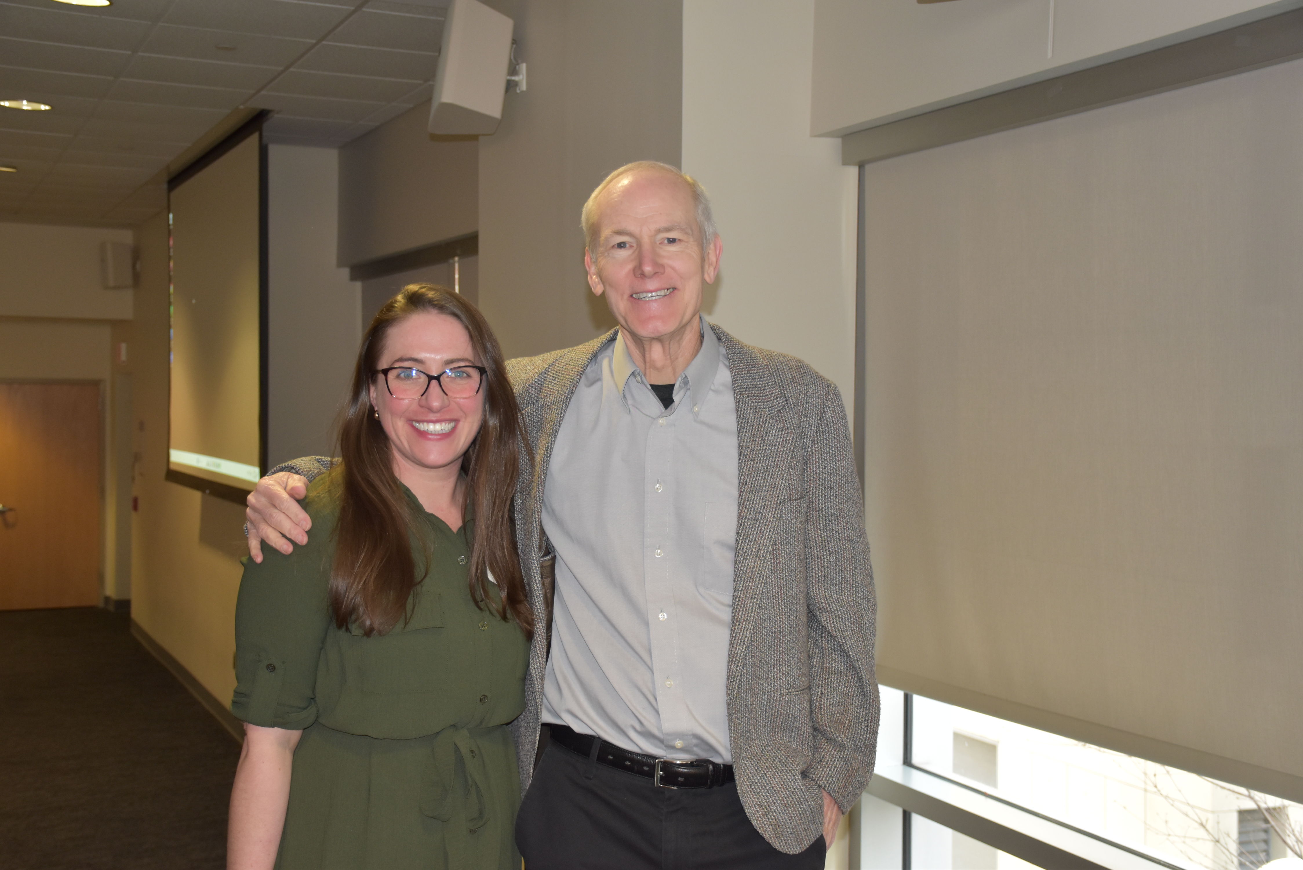 Faculty member poses with keynote speaker John Murphy, PhD