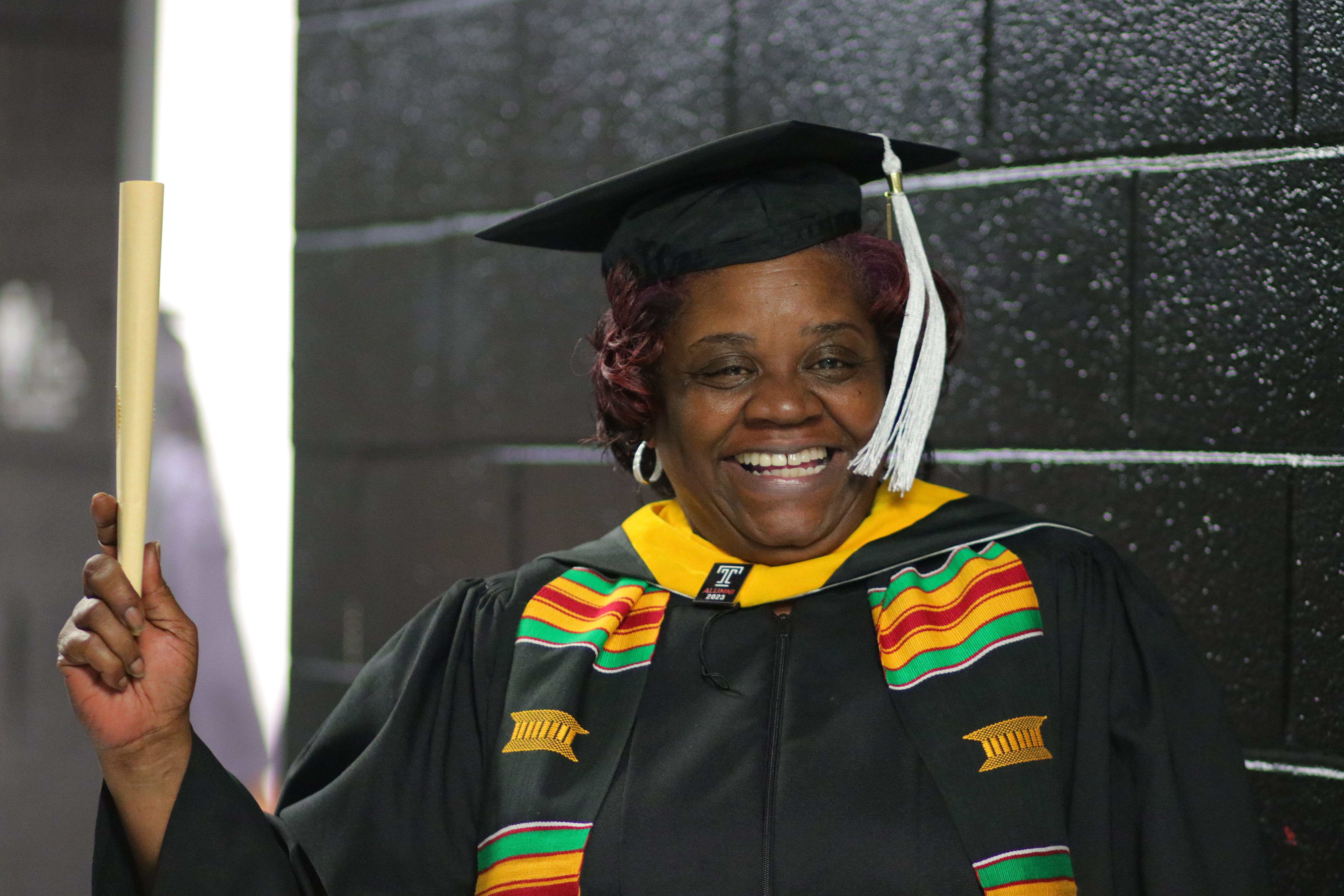 Graduate raises diploma in celebration