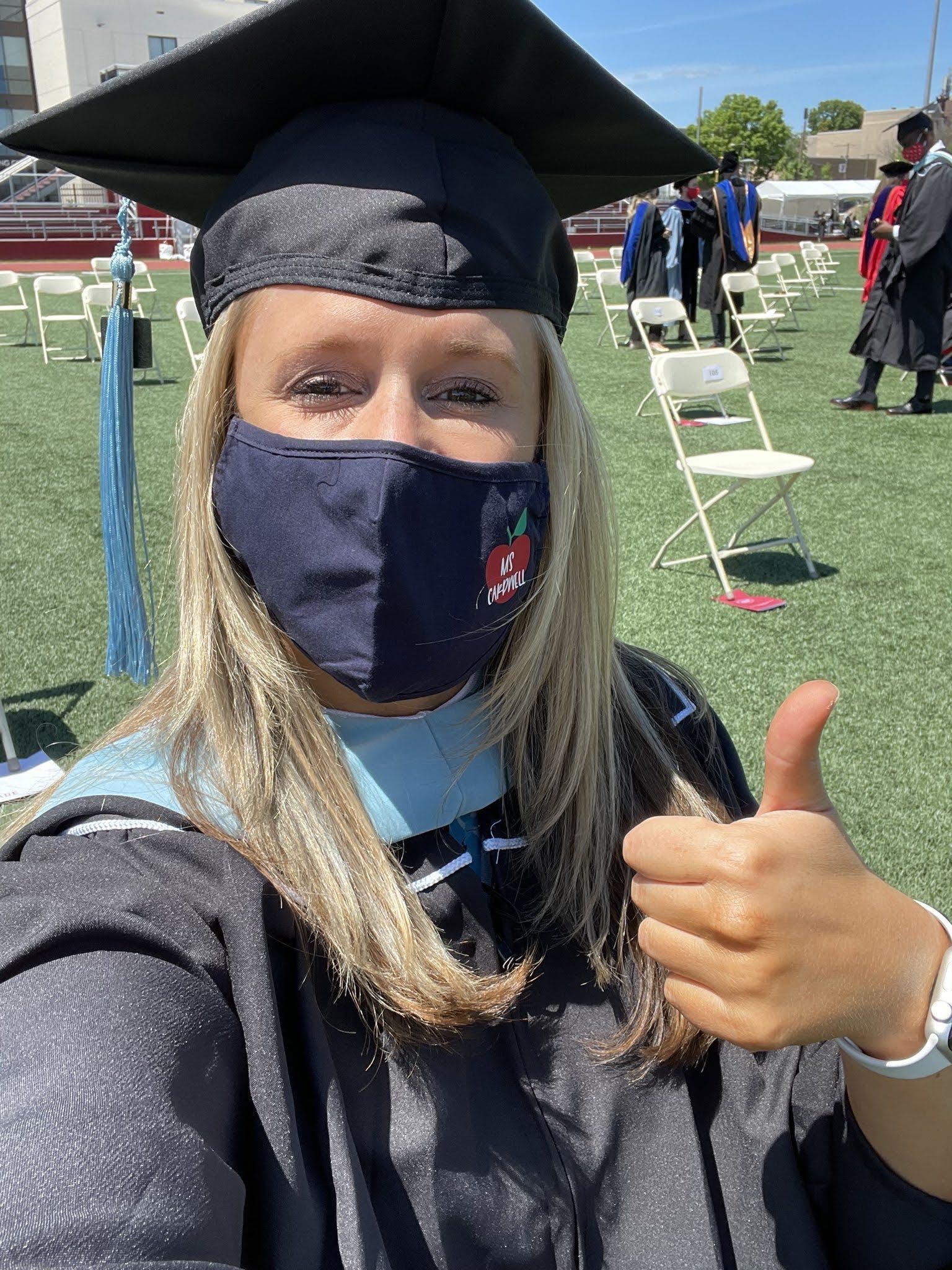 graduate gives a thumbs up