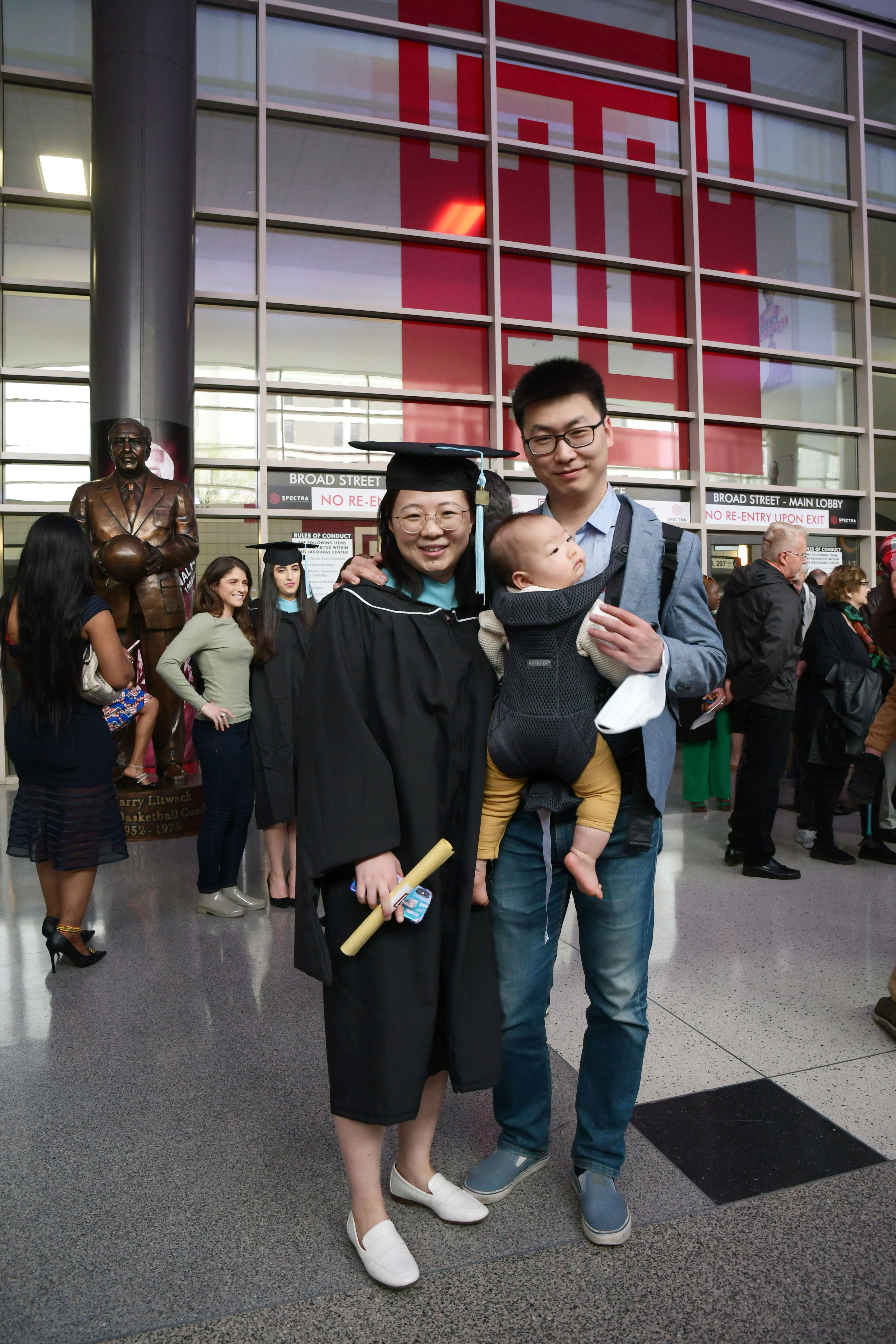 graduate poses with family