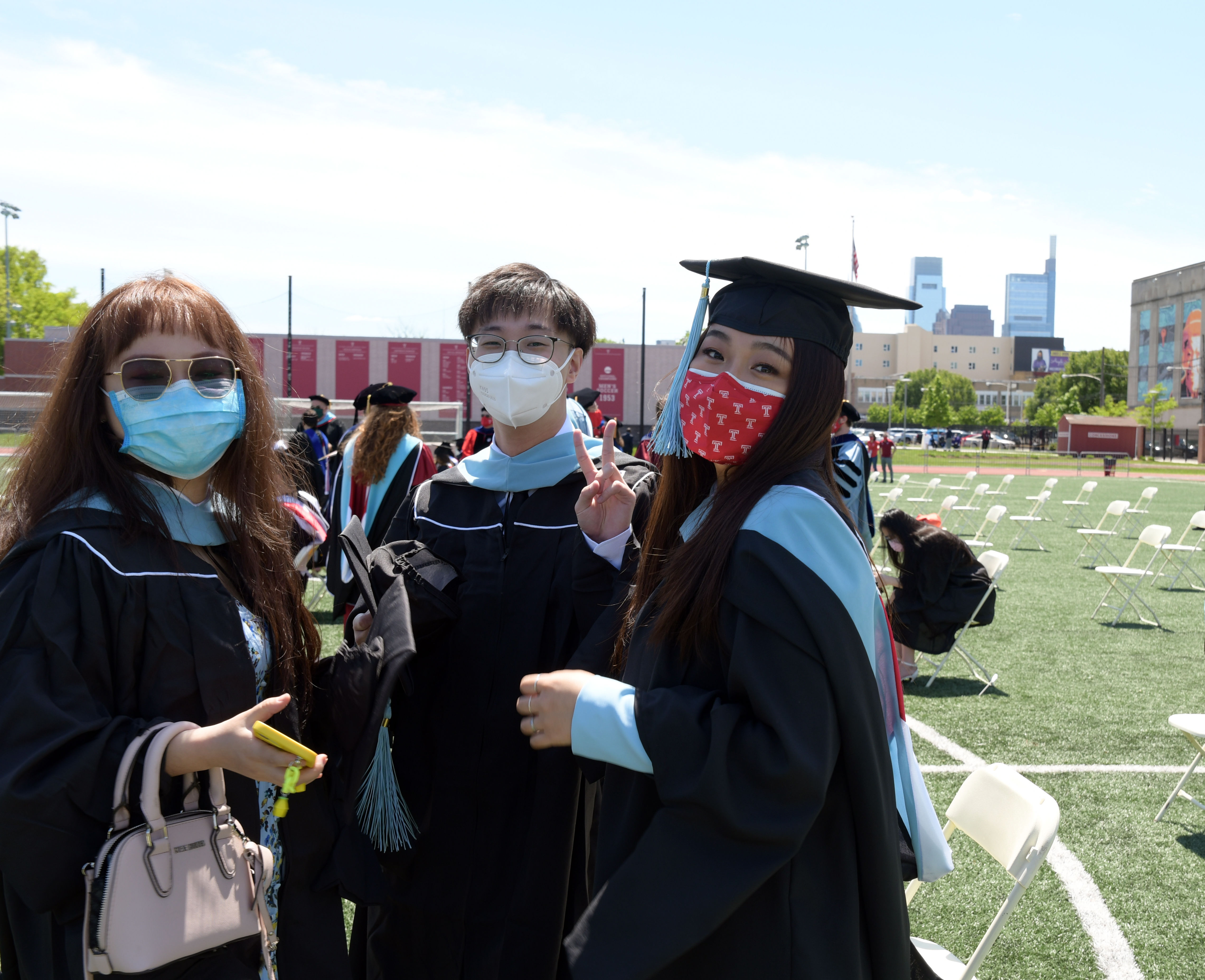 three graduates pose for photo