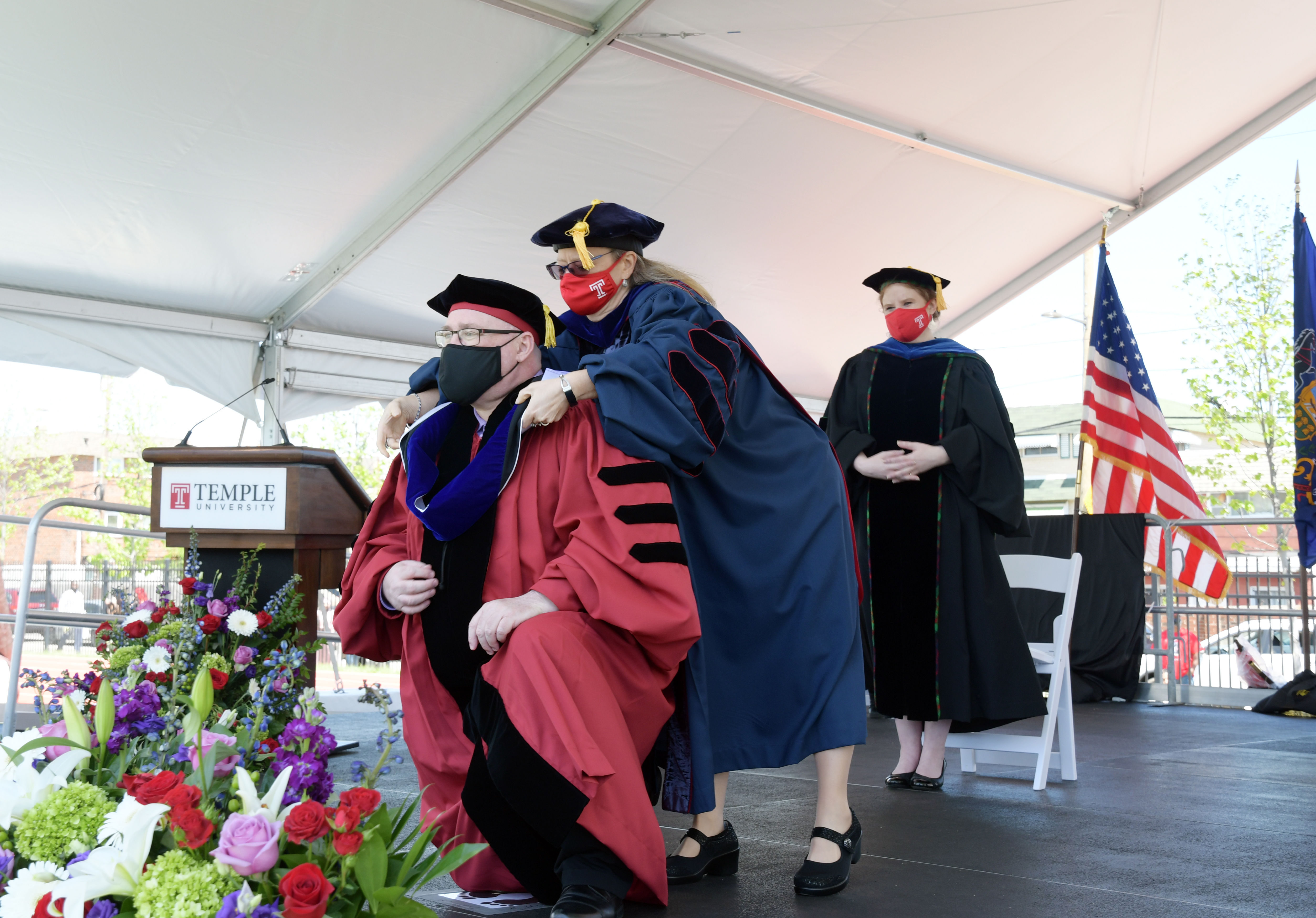 doctoral candidate is hooded by faculty member