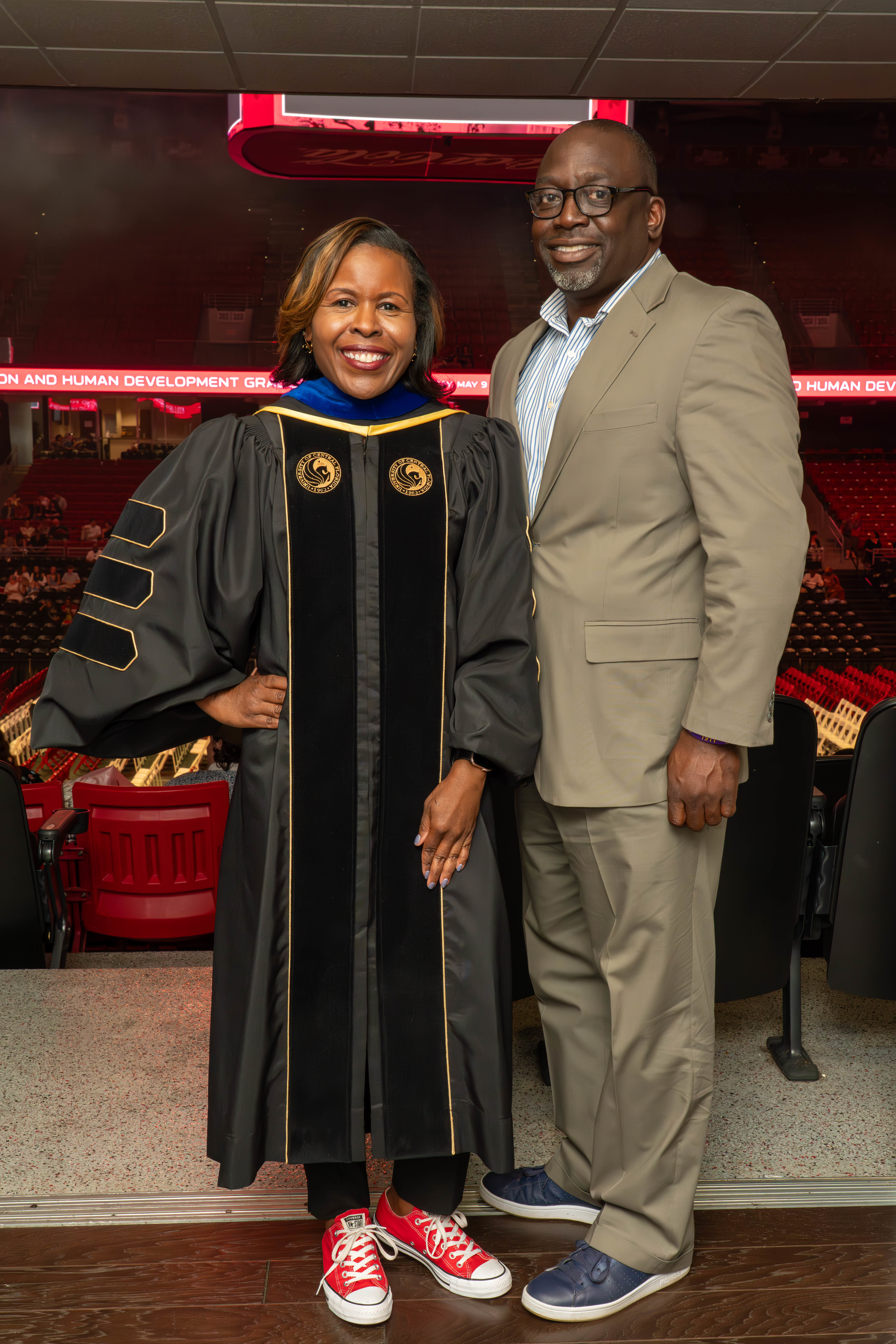 Dean Shealey poses with special guest on stage at graduation