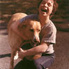 Image of Andrew Spector hugging a dog
