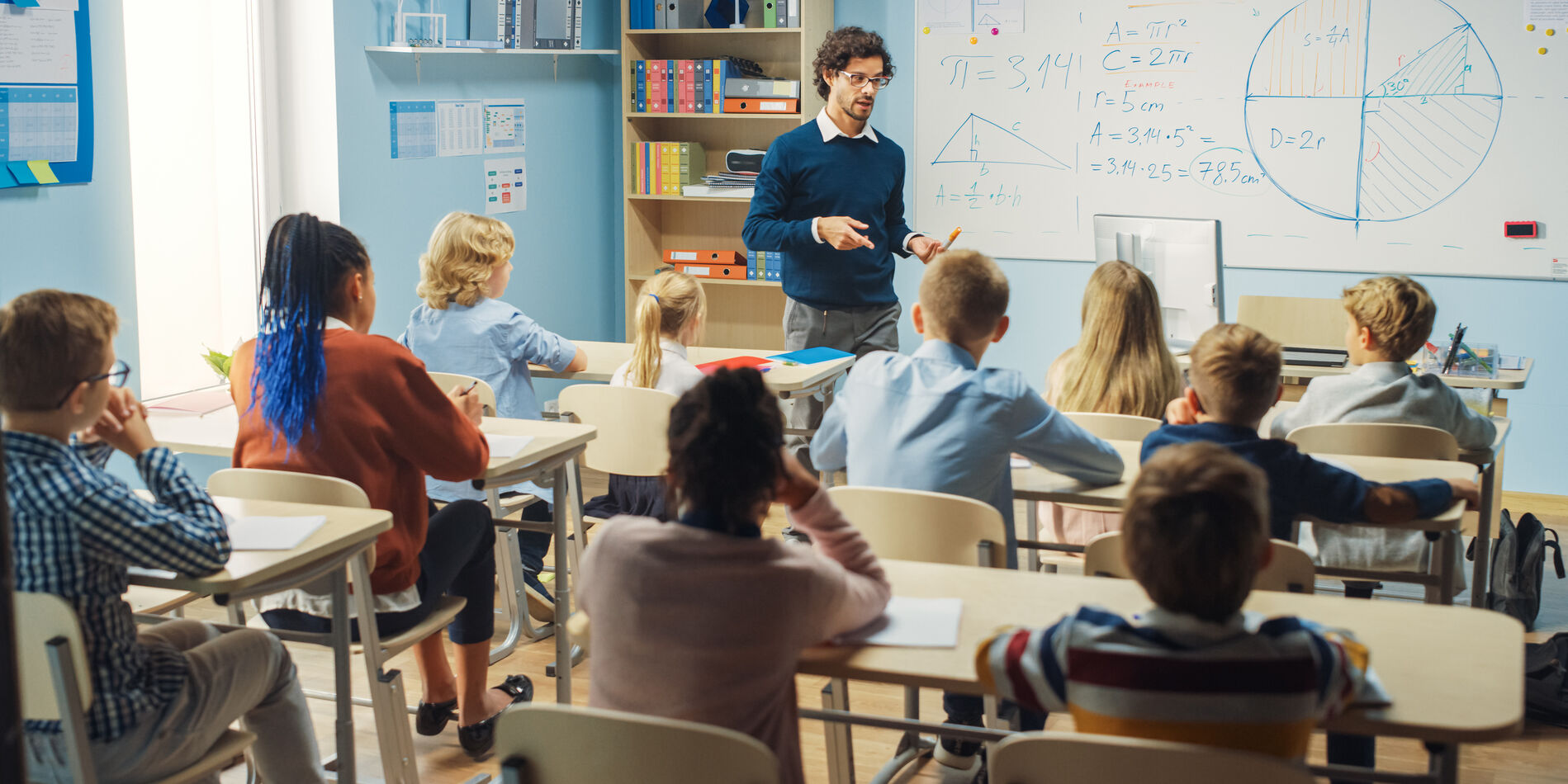 Teacher in front of a classroom of children