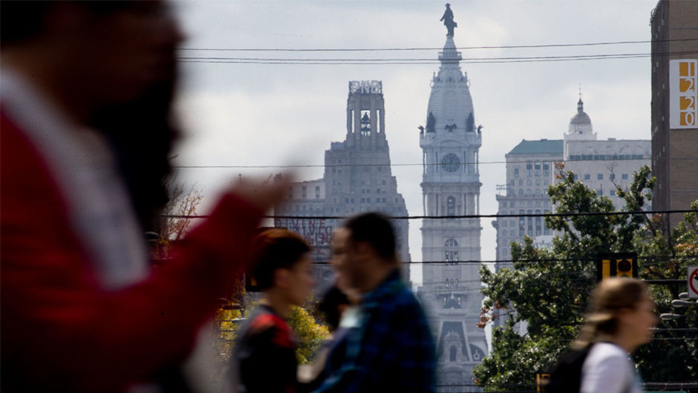 Temple students walking in front of Philadelphia skyline