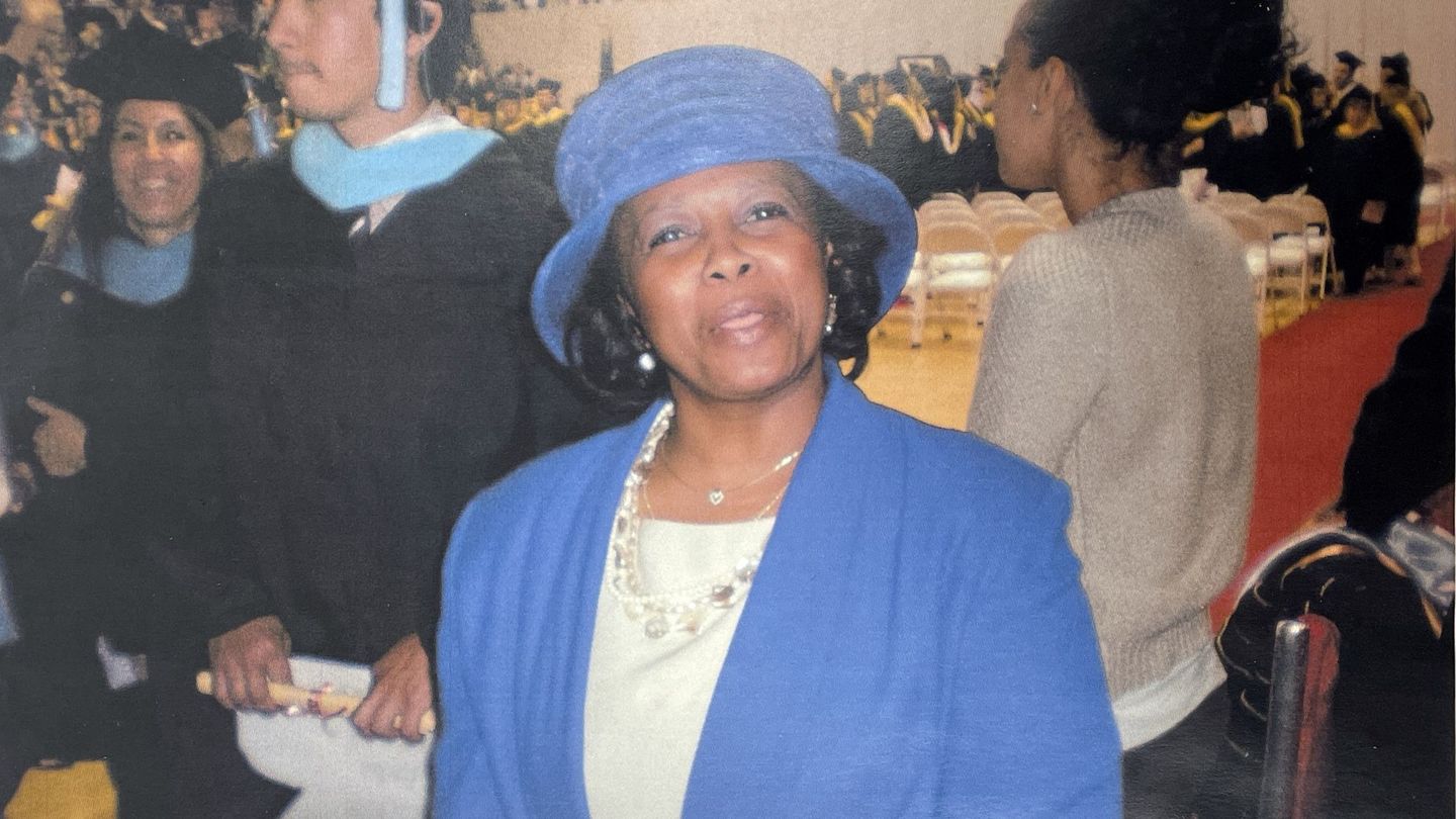 Valerie Williams in a light blue suit and hat. 