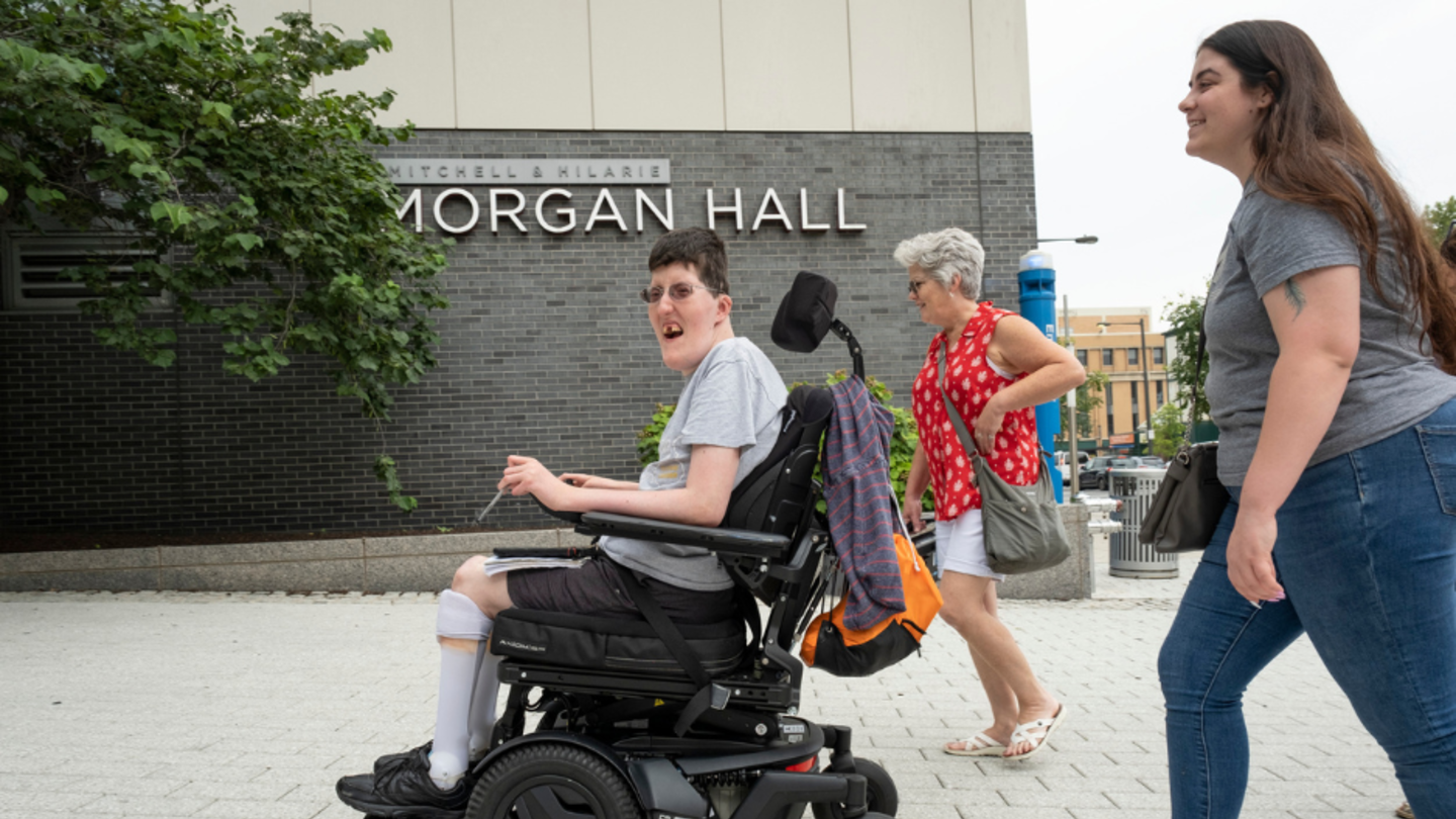 Photo of a person on a wheelchair going back to their residence hall after class