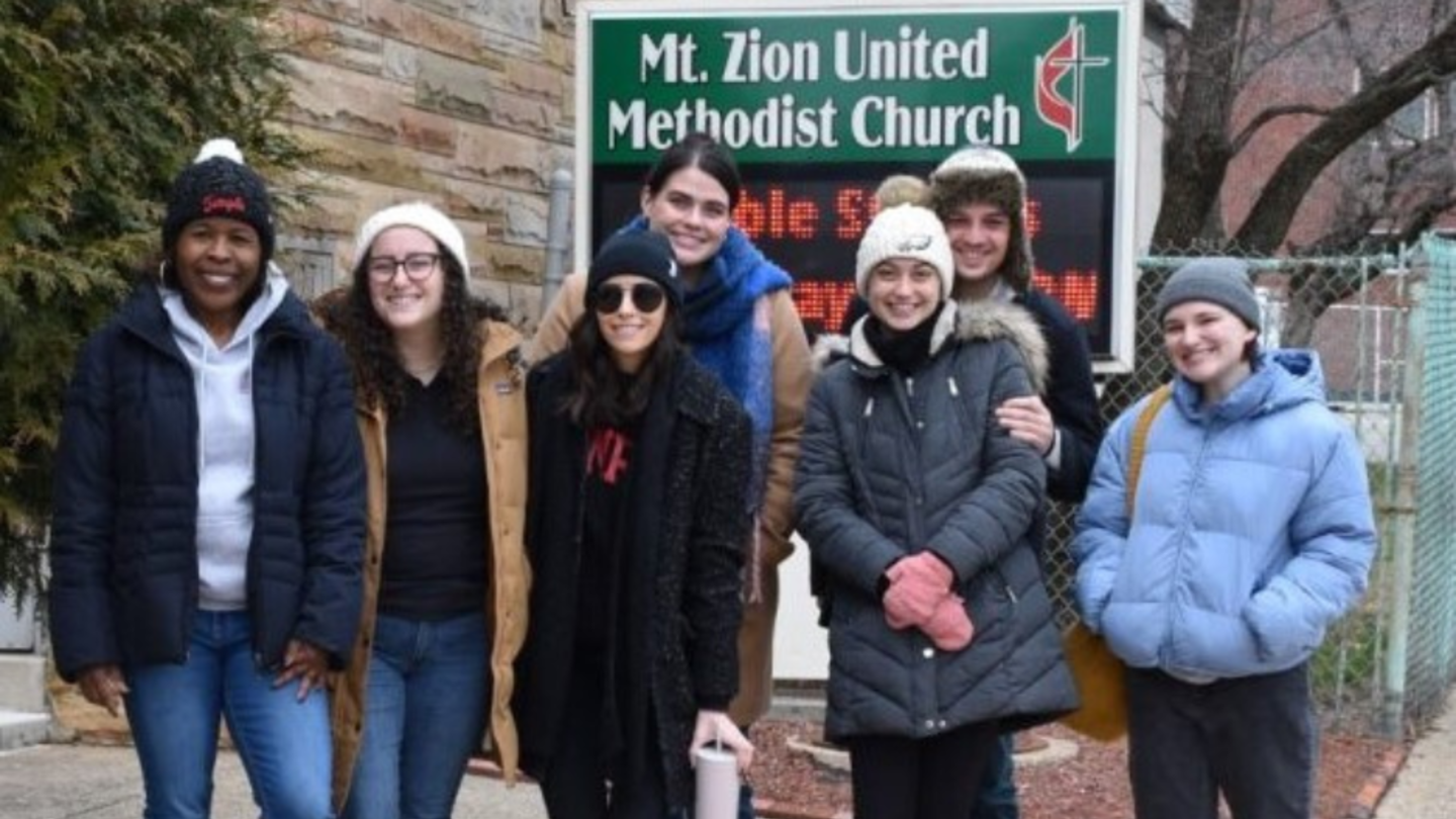 Dean Monika Shealey with CEHD Staff in front of a church.