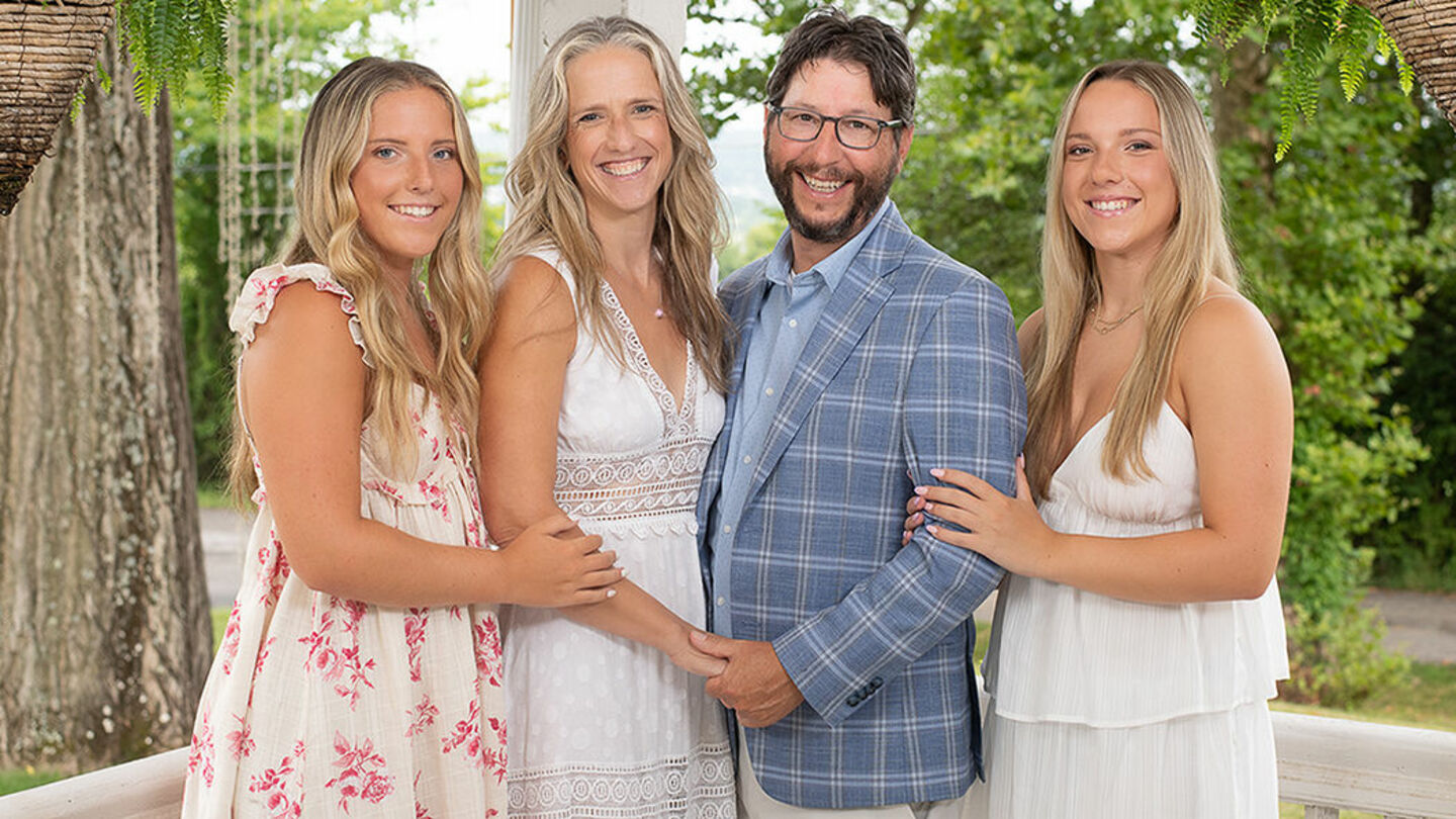 Bibelheimer family photo - young adult twin daughters on either side of Christine and Jerome