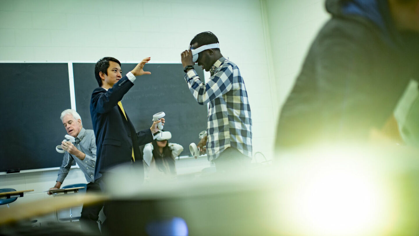 Di Liu, assistant professor of instruction in the Department of Teaching and Learning in the College of Education and Human Development is the coordinator of the TESOL MSEd program, the English language teaching certificate program and the instructional learning technology certificate program. mage of Di Liu demonstrating virtual reality technology with teachers and students in a classroom.