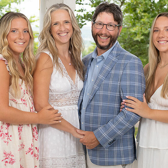 Bibelheimer family photo - young adult twin daughters on either side of Christine and Jerome